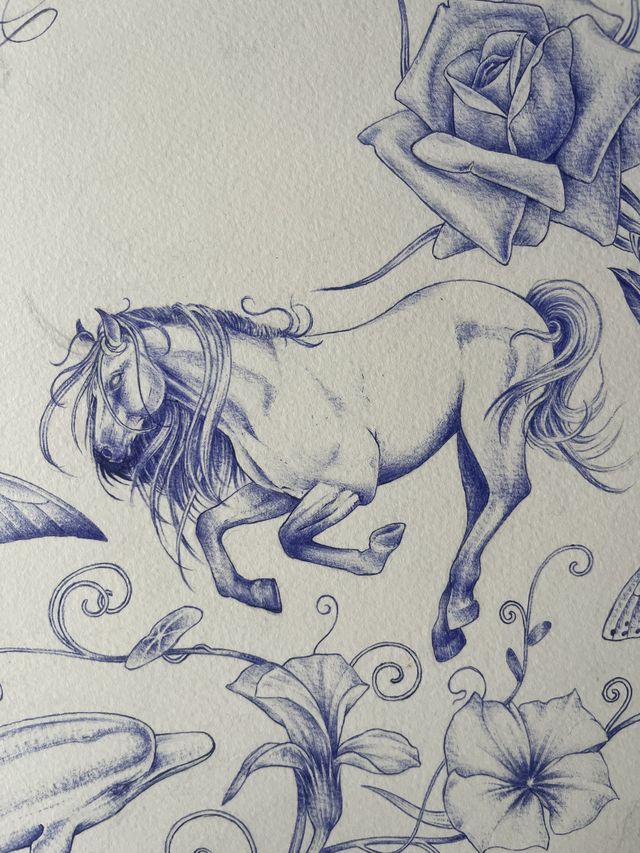 Blue ballpoint flash — a bucking horse beneath a large rose, with lilies and morning glories.