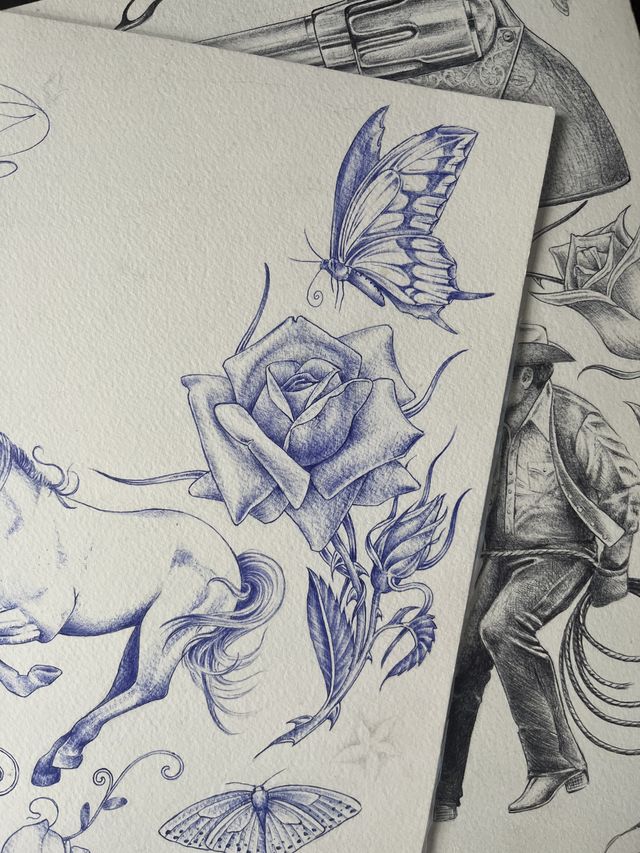 Blue ballpoint flash sheet — swallowtail butterfly, an open rose, a horse, and a cowboy with a lasso.