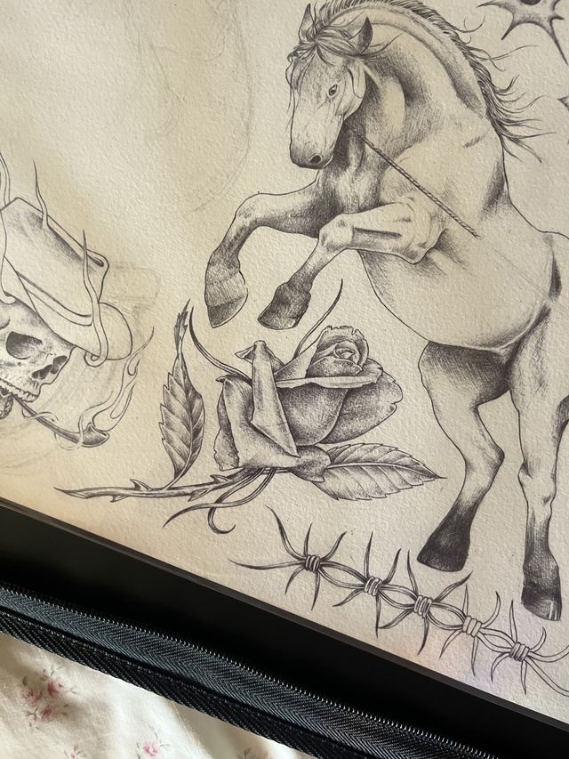 Graphite western flash sheet — a rearing horse, a rose, a skull in a cowboy hat and barbed wire.