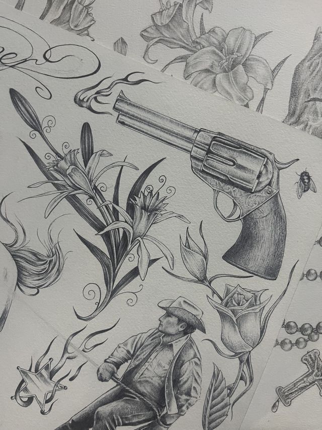 Graphite western flash sheet — a smoking revolver, lilies, a rose and a seated cowboy.