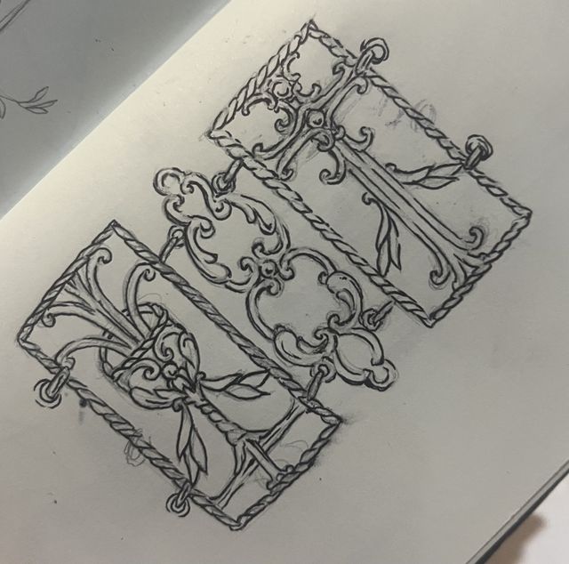 Pencil sketch of ornamental wrought-iron panels with a cross and leaves.