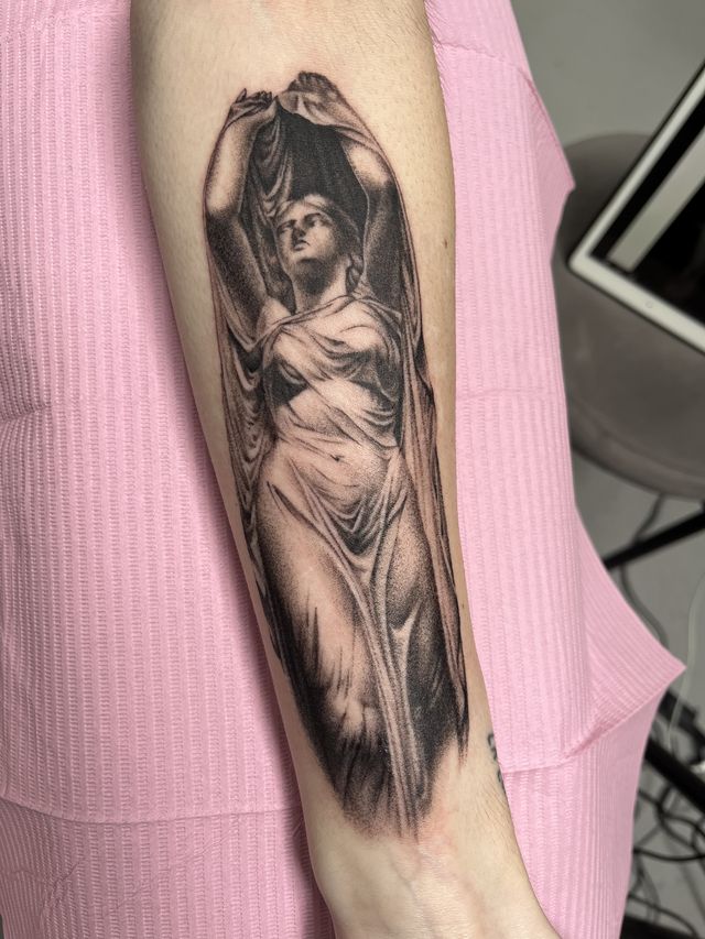 Realism study of a classical draped statue with raised arms, on a forearm.